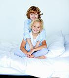 Portrait of young siblings in bed