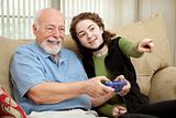 Teen Helps Grandpa with Video Game