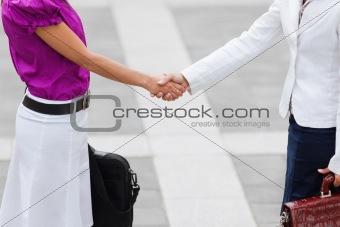businesswomen shaking hands