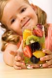 Happy healthy little girl with fruit salad