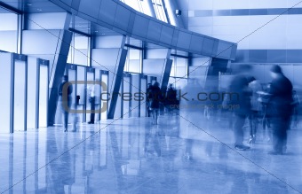 People in a modern architectural interior. Motion blur