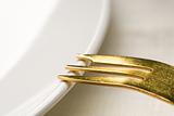 Gold fork on a plate