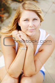 Portrait of a happy beautiful young blonde woman at the beach.