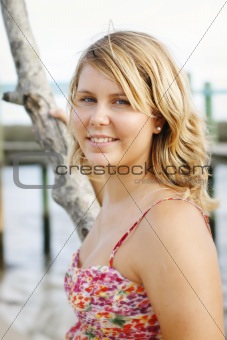 Portrait of a happy beautiful young blonde woman at the beach.