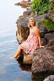 Beautiful young blonde woman at the water’s edge.