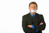 Businessman With His Arms Folded  And His Mouth Taped Shut 