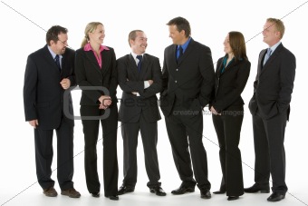 Group Of Business People Standing Around Conversing 
