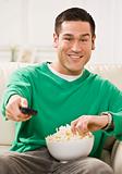 Attractive Asian Man with Popcorn and Remote Control