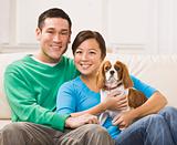 Attractive Asian Couple Holding Dog