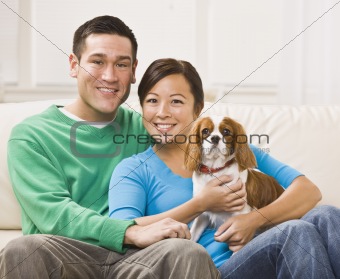 Attractive Asian Couple Holding Dog