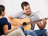 Happy Young Couple with Guitar