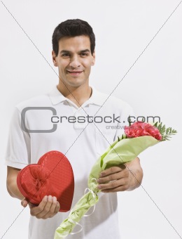 Happy Man Holding Candy and Flowers