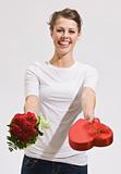 Attractive Young Woman Holding Out Roses and Candy