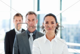 Serious businesswoman in front of her team