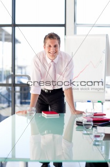Smiling businessman standing in a presentation