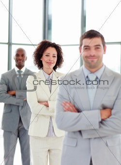 Friendly young businesswoman with folded arms