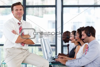 Senior manager with crossed arms in a call center