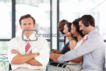 Senior leadership with crossed arms in a call center