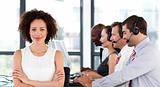 Attractive businesswoman with folded arms in a call center