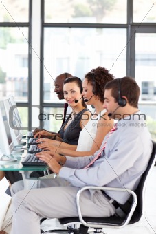 Smiling young businesswoman in a call center