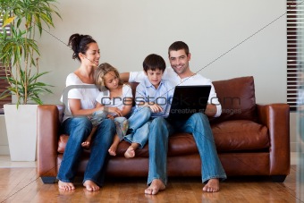 Family playing together with a laptop