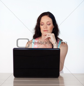 Serious woman working with her laptop