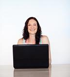 Portrait of a smiling girl working with a laptop