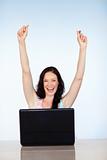 Happy woman having success with laptop
