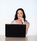 Woman working with her laptop looking at the camera