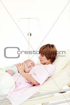 Mother taking care of her newborn baby with copy-space