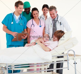 Doctors attending to a patient and a newborn baby
