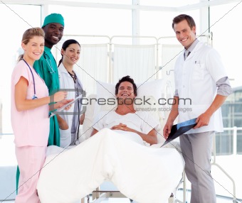 Doctors attending to a patient smiling at the camera