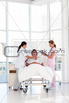 Female doctor and nurse caring for a patient