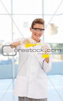 Blonde scientist examining a test-tube
