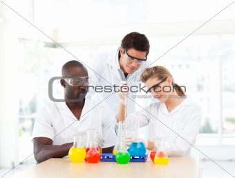 Scientists examining test-tubes