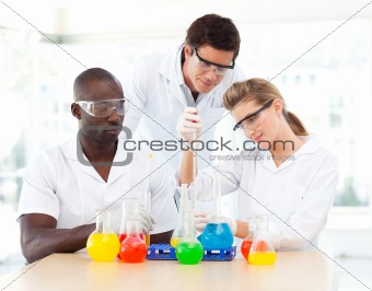Young scientists examining test-tubes