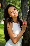 Beautiful young women holding apple in the garden
