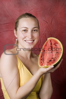 Smiling young woman with watermelon