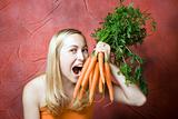 Smiling woman with fresh carrots