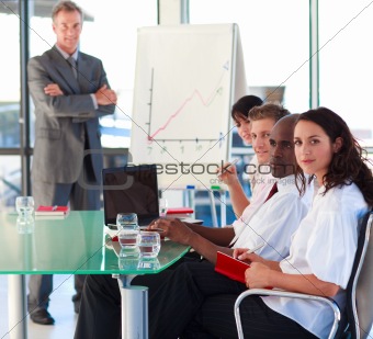 Mature manager in a presentation with folded arms