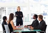 Businesswoman smiling with folded arms in a meeting