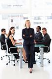 Serious businesswoman with folded arms in a meeting