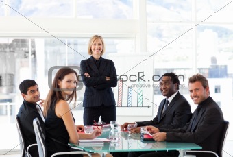 Businesswoman smiling at the camera in a meeting