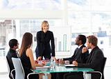 Businesswoman smiling at her colleagues in a meeting