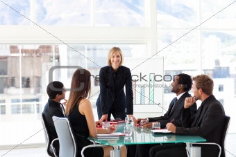 Female manager smiling at the camera in a meeting