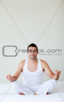 Young man doing exercises in bed