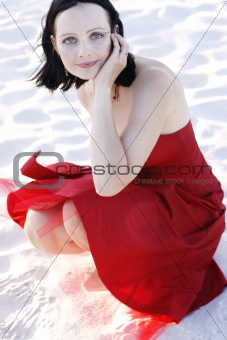 Portrait of a beautiful woman in a red dress outdoors.