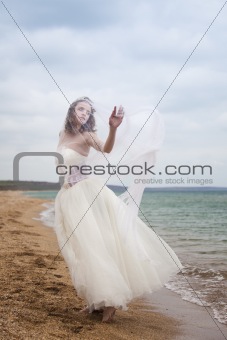 	beautiful bride  dancing on the beach 