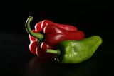Red and green  pepper over black  