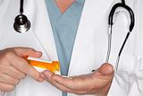 Male Doctor Abstract Pouring Out Pills from a Prescription Bottle